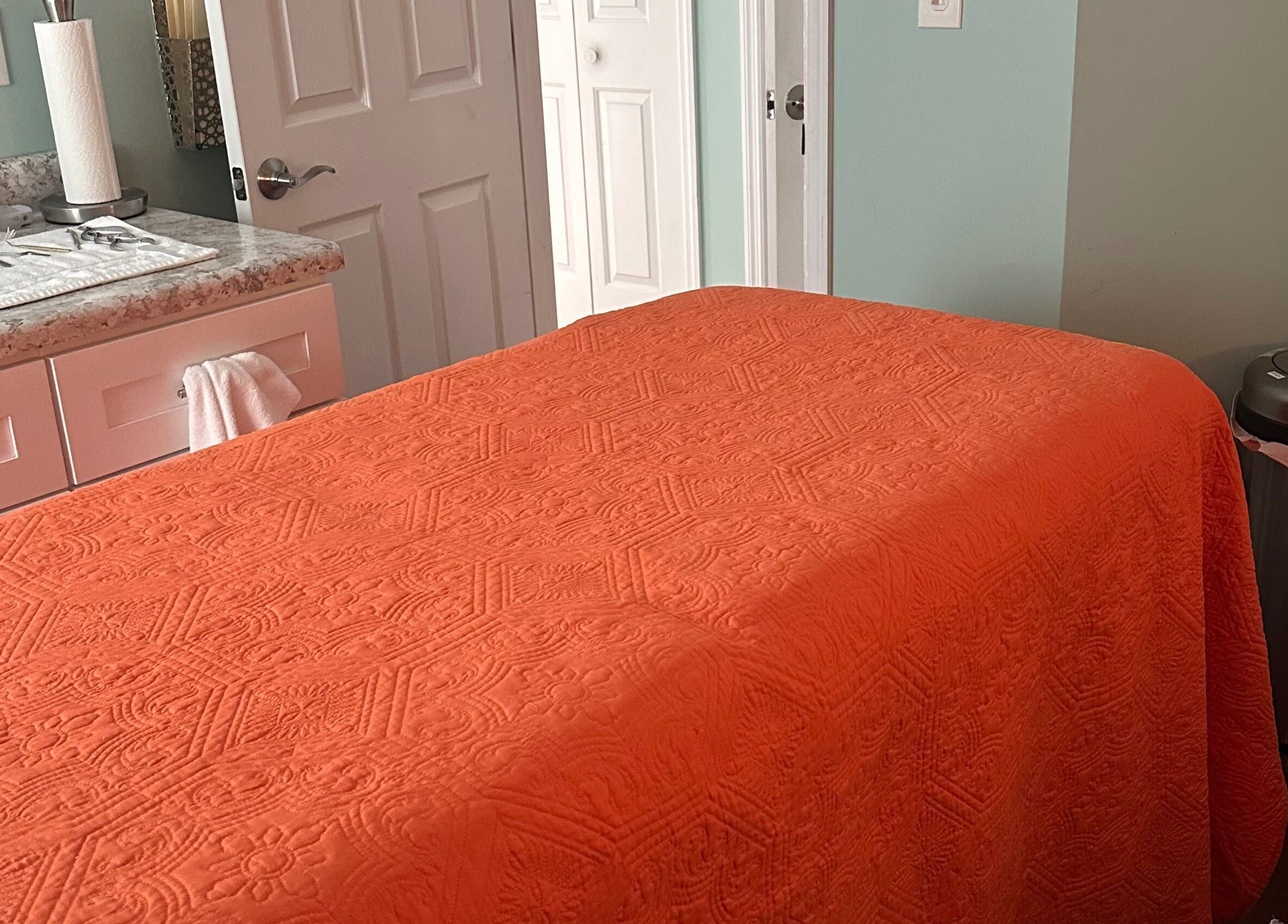 Massage table with orange cover at Falling Waters Massage, Mad Lasher studio, Wilmington, North Carolina, US.