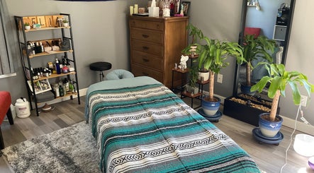 Relaxing massage room at Falling Waters Massage, Rocky Point, North Carolina, US, with cozy decor and plants.