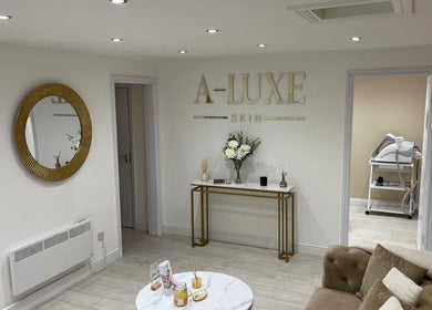 Elegant lounge at A LUXE SKIN, Birmingham, England, with chic decor and plush seating.