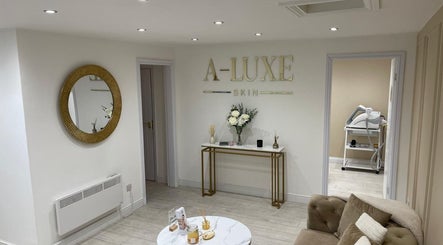 Elegant lounge at A-Luxe Skin, Birmingham, England, GB with chic decor and plush seating.