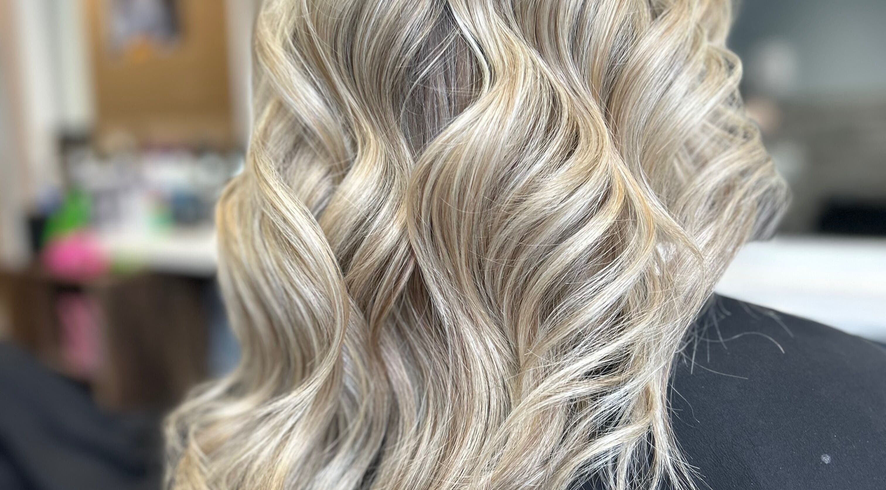 Elegant blonde curls styled at EmmaJane Hairdressing, Cardross, Scotland, GB, in an upscale salon setting.