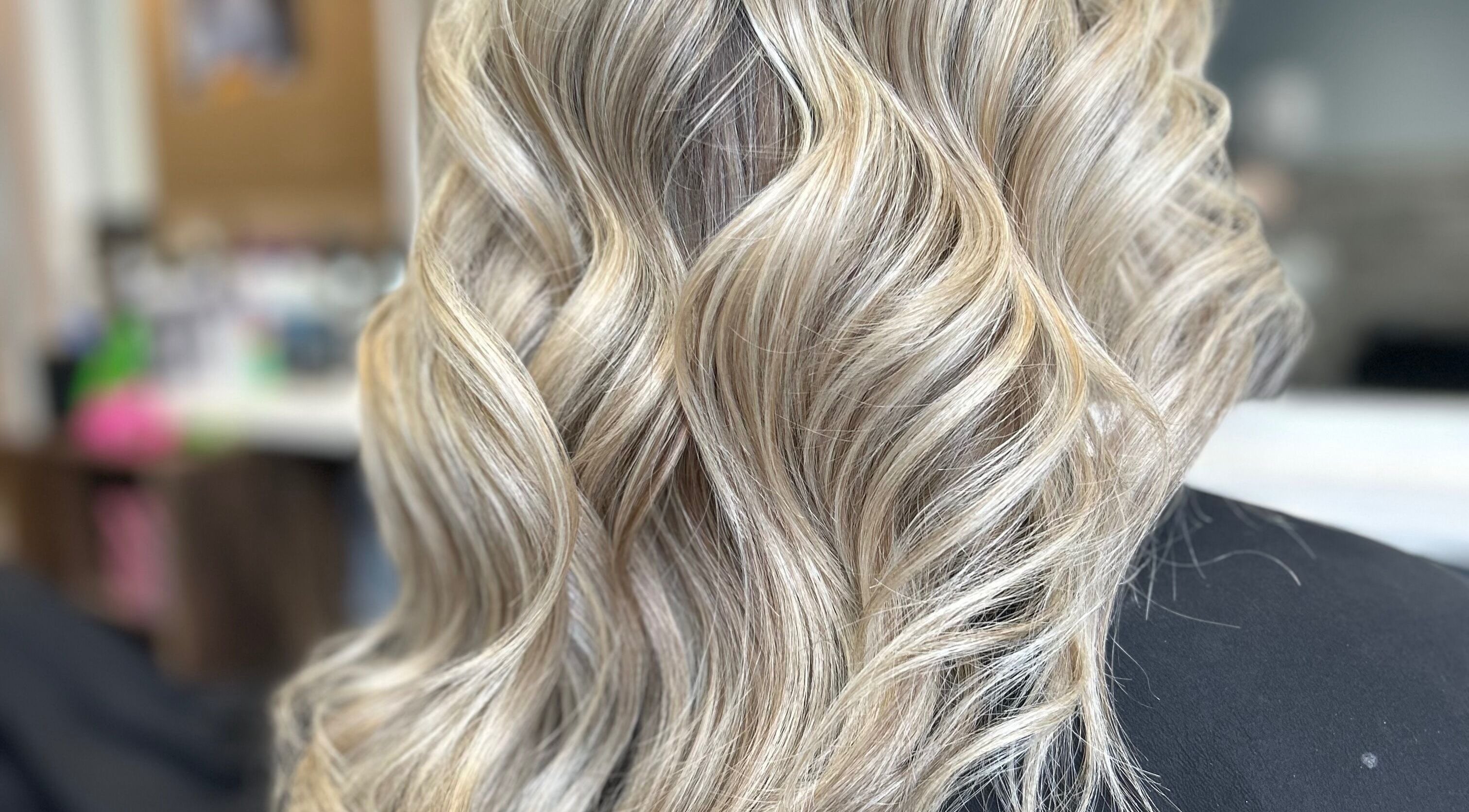 Elegant blonde curls styled at EmmaJane Hairdressing, Cardross, Scotland, GB, in an upscale salon setting.
