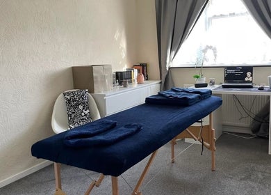 Calm massage room at Pain Therapy- massage, Houghton Regis, England, GB with a massage table.