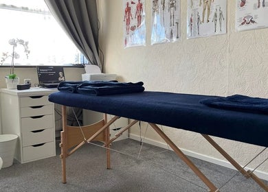 Massage room at Pain Therapy- massage, Houghton Regis, England, GB with a cozy table and soothing decor.