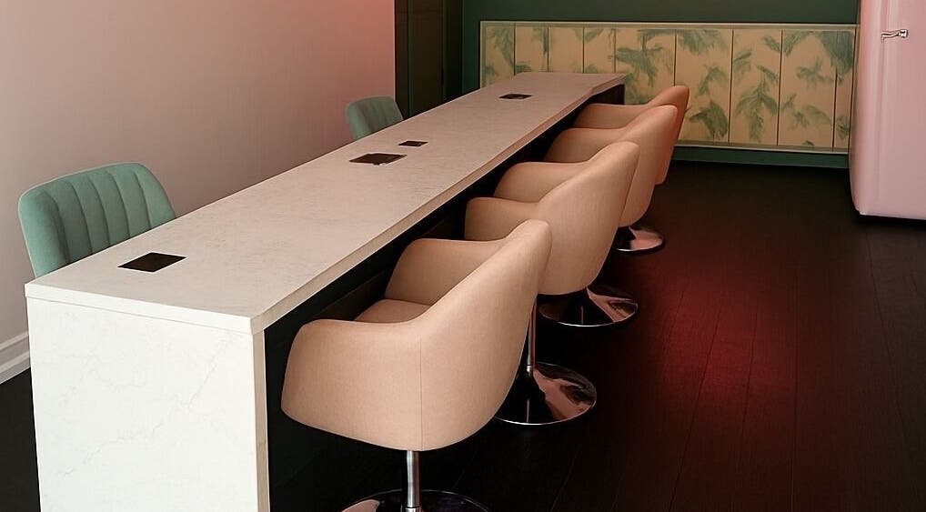 Sleek nail bar setup at THE DOLL HOUSE NAILS, Bristol, England, GB with modern seating and elegant decor.