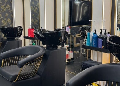 Luxurious beauty salon interior at Armstyle, Glendale, California, US, showcasing sleek black wash stations and modern décor.