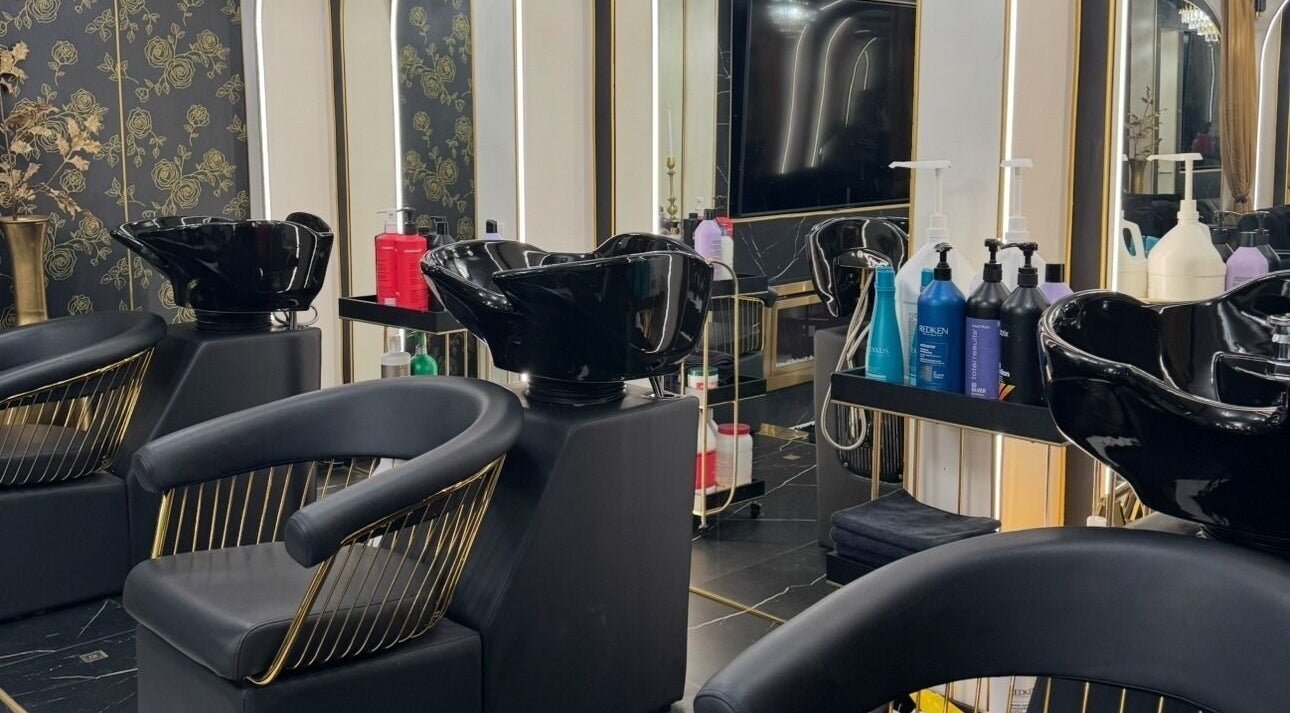 Luxurious beauty salon interior at Armstyle, Glendale, California, US, showcasing sleek black wash stations and modern décor.