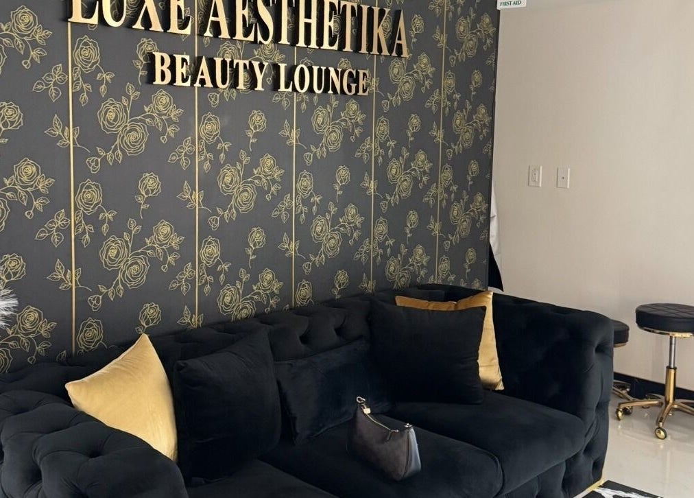 Elegant lounge area at Armstyle, Glendale, California, US with plush sofa and gold accented decor.