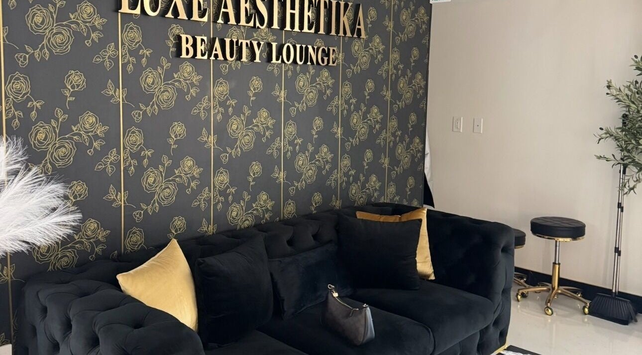 Elegant lounge area at Armstyle, Glendale, California, US with plush sofa and gold accented decor.