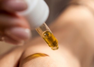 A dropper dispensing golden oil at Demo Salon, Coimbra, Coimbra, PT, reflecting wellness and skincare.