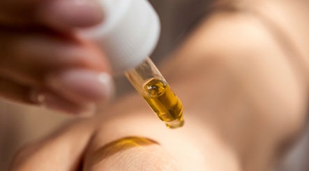 A dropper dispensing golden oil at Demo Salon, Coimbra, Coimbra, PT, reflecting wellness and skincare.