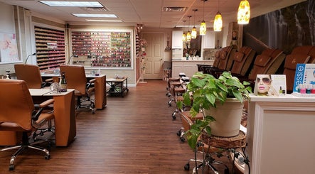 Cozy interior of Quality Nails Spa in Hingham, MA, US with manicure stations and soothing decor.
