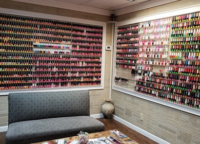 Vibrant nail polish display at Quality Nails Spa in Hingham, MA, US, showcasing diverse color options.