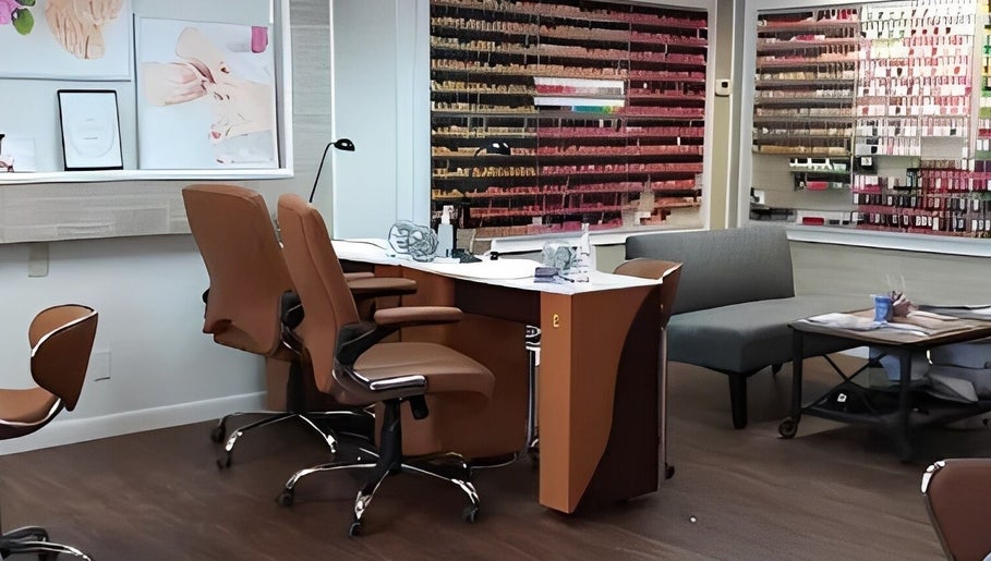 Cozy interior of Belle Nails & Lashes Hingham, showcasing elegant chairs and nail polish display in Hingham, MA, US.