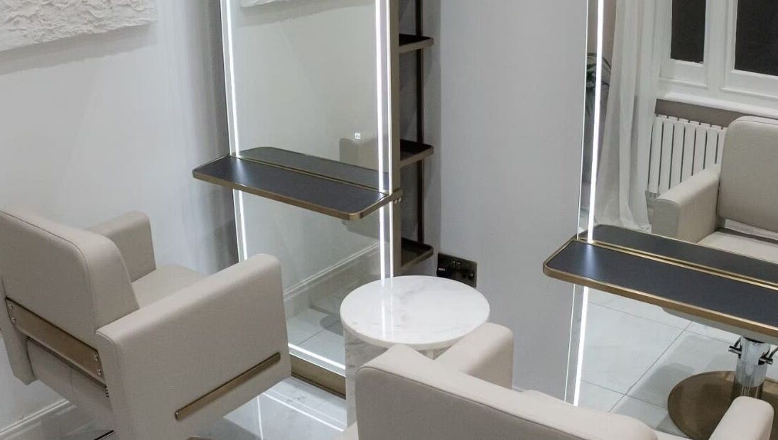 Chic salon interior with modern mirrors at Tresses By Em, GB. Perfect blend of elegance and functionality.