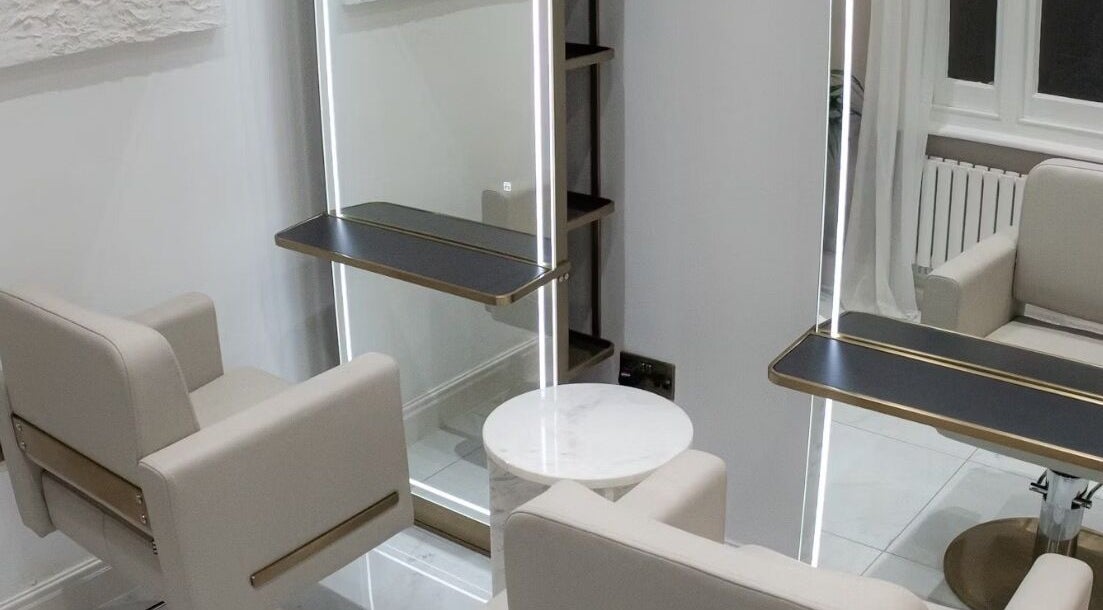 Chic salon interior with modern mirrors at Tresses By Em, GB. Perfect blend of elegance and functionality.