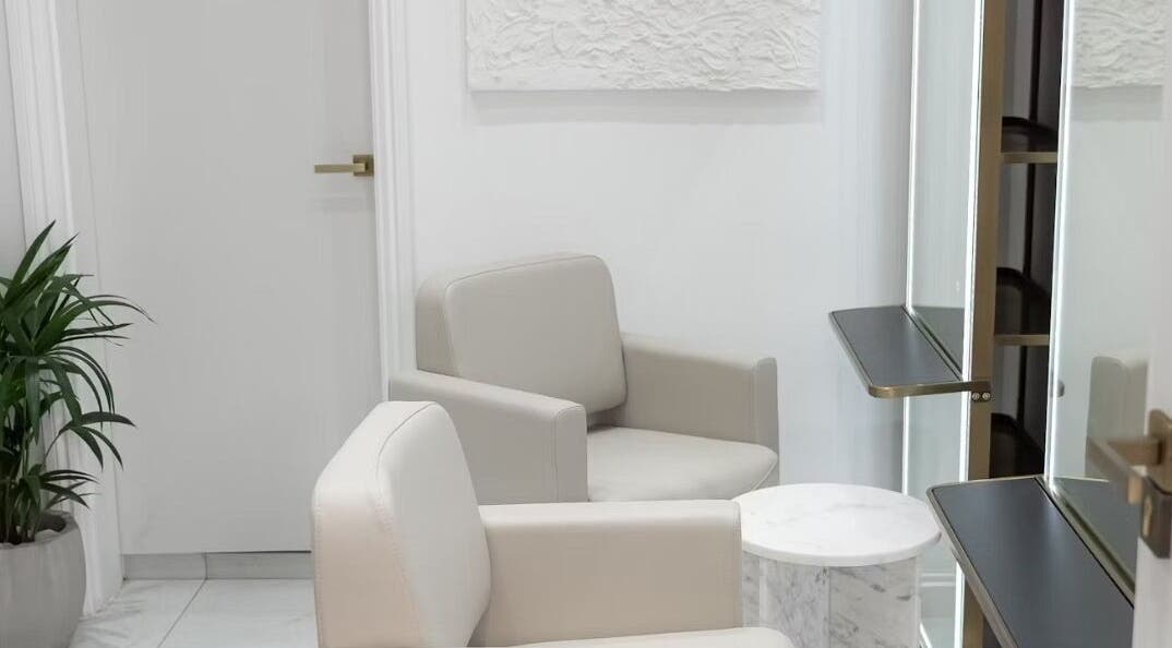 Modern, elegant salon interior at Tresses By Em in GB, featuring plush seating and stylish decor.