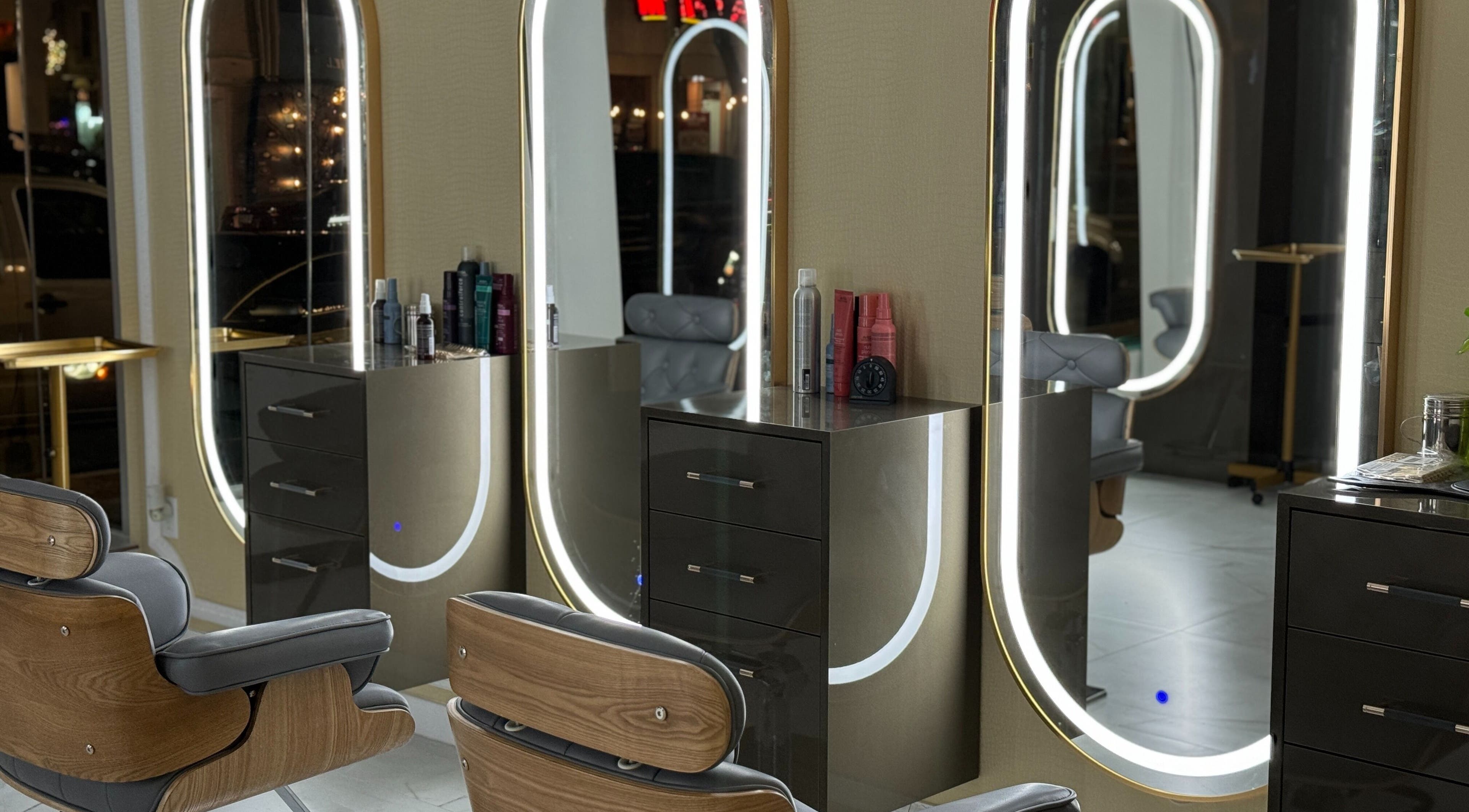 Elegant salon chairs and mirrors at Revival Salon, Huntington, New York, US, showcasing luxury and style.