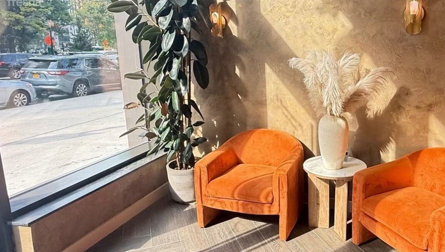 Elegant seating and decor at Chic Luxury hair studio, Valley Stream, New York, US, with natural light.
