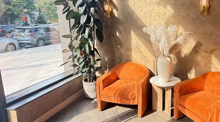 Elegant seating and decor at Chic Luxury hair studio, Valley Stream, New York, US, with natural light.