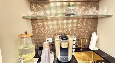 Chic Luxury hair studio's elegant coffee station with gold accents in Valley Stream, New York, US.