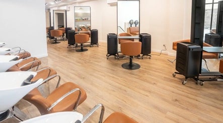 Chic luxury hair studio in New York, New York, US with modern styling chairs and mirrors.