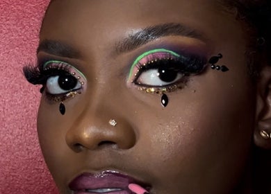 Close-up of vibrant eye makeup at Poised Beauty in Sint Maarten, SX, showcasing colorful and bold designs.