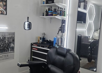 Modern barber station at The Executive Barber - Moe Gaines, Phoenix, Arizona, US with sleek tools and mirrors.