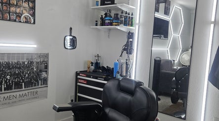 Modern barber station at The Executive Barber - Moe Gaines, Phoenix, Arizona, US with sleek tools and mirrors.