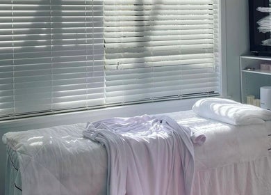 Relaxing spa room at Fusion skin beauty west Auckland in Auckland, NZ with bed and natural light.