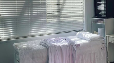 Relaxing spa room at Fusion skin beauty west Auckland in Auckland, NZ with bed and natural light.