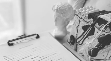 Client consultation form at Fusion Skin Beauty in West Auckland, showcasing artistic decor in Auckland, NZ.