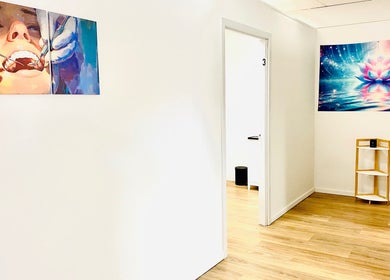 Bright hallway at Oral Health & Beauty Spa in Canning Vale, Western Australia showcasing vibrant artwork.