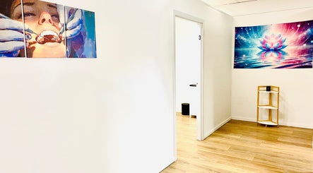 Bright hallway at Oral Health & Beauty Spa in Canning Vale, Western Australia showcasing vibrant artwork.