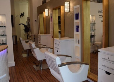 Stylish salon interior at Lily Of New York in Boca Raton, Florida, US featuring chic chairs and modern decor.