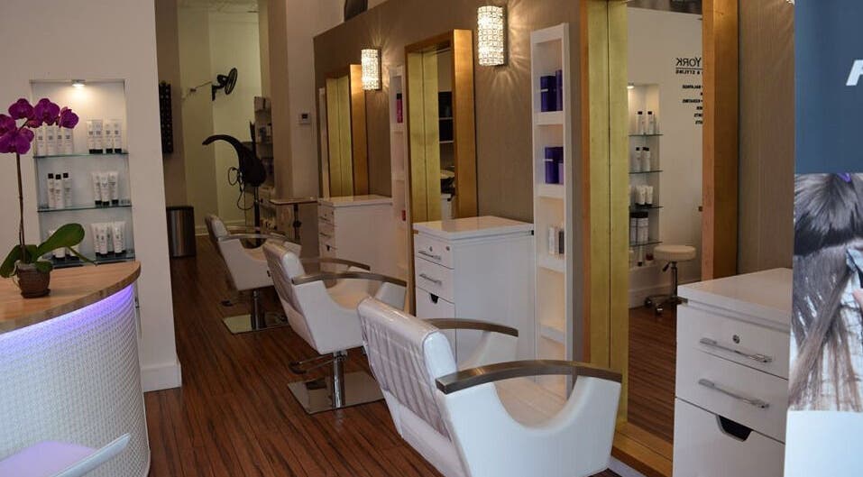 Stylish salon interior at Lily Of New York in Boca Raton, Florida, US featuring chic chairs and modern decor.