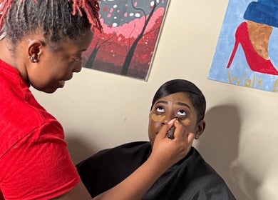 Makeup artist at Unapologetically R. Nicole applying cosmetics in Fultondale, Alabama studio.