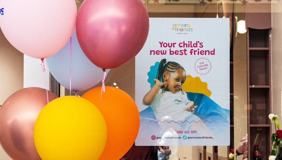 Bright balloons and a welcoming poster at Amara and Friends kiddies Salon Sandton, Gauteng, ZA.