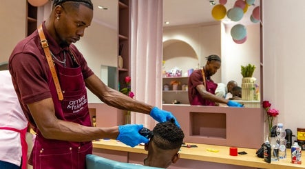 Hairstylist giving a kid's haircut at Amara and Friends kiddies Salon, Sandton, Gauteng, ZA.