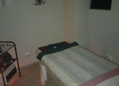 Cozy massage room at Rays Massage, Cape Town, Western Cape, ZA, with a tranquil bed setup for relaxation.