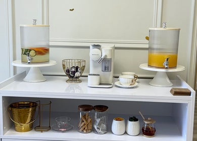 Refreshment station at Elite Spa and Beauty in Cape Town, Western Cape, ZA with infused water and coffee options.
