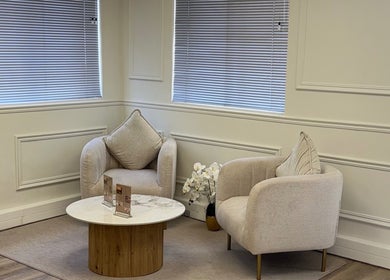 Elegant seating area in Elite Spa and Beauty, Cape Town, Western Cape, ZA with plush chairs and a marble table.