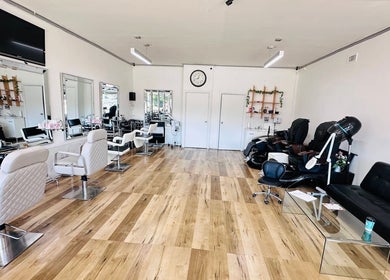Bright salon interior at Jo Beauty Experts in Melbourne, Victoria, AU with modern chairs and large mirrors.