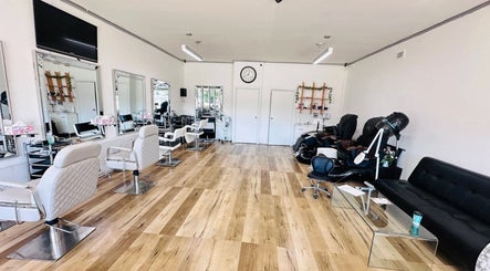 Bright salon interior at Jo Beauty Experts in Melbourne, Victoria, AU with modern chairs and large mirrors.