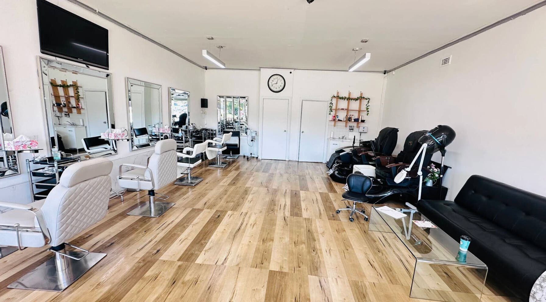 Bright salon interior at Jo Beauty Experts, Melbourne, Victoria, AU showcasing modern styling chairs and decor.