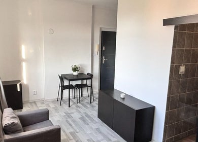 Modern cozy room at Blinkz, Hlavní Město Praha, CZ showcasing a chic gray chair and sleek table setup.