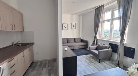 Bright living area with modern decor and kitchen at Blinkz, Hlavní Město Praha, CZ.