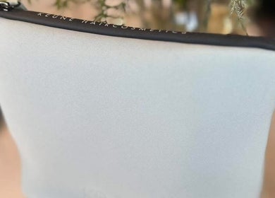 Sleek grey cosmetic pouch displayed at Lumi Hair Lounge, Melbourne, Victoria, AU.
