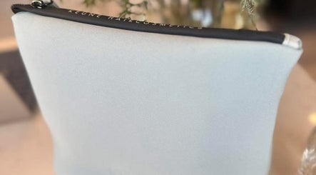 Sleek grey cosmetic pouch displayed at Lumi Hair Lounge, Melbourne, Victoria, AU.