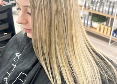 Blonde hair styling at Lumi Hair Lounge, Melbourne, Victoria, AU, showcases smooth and sleek finish.